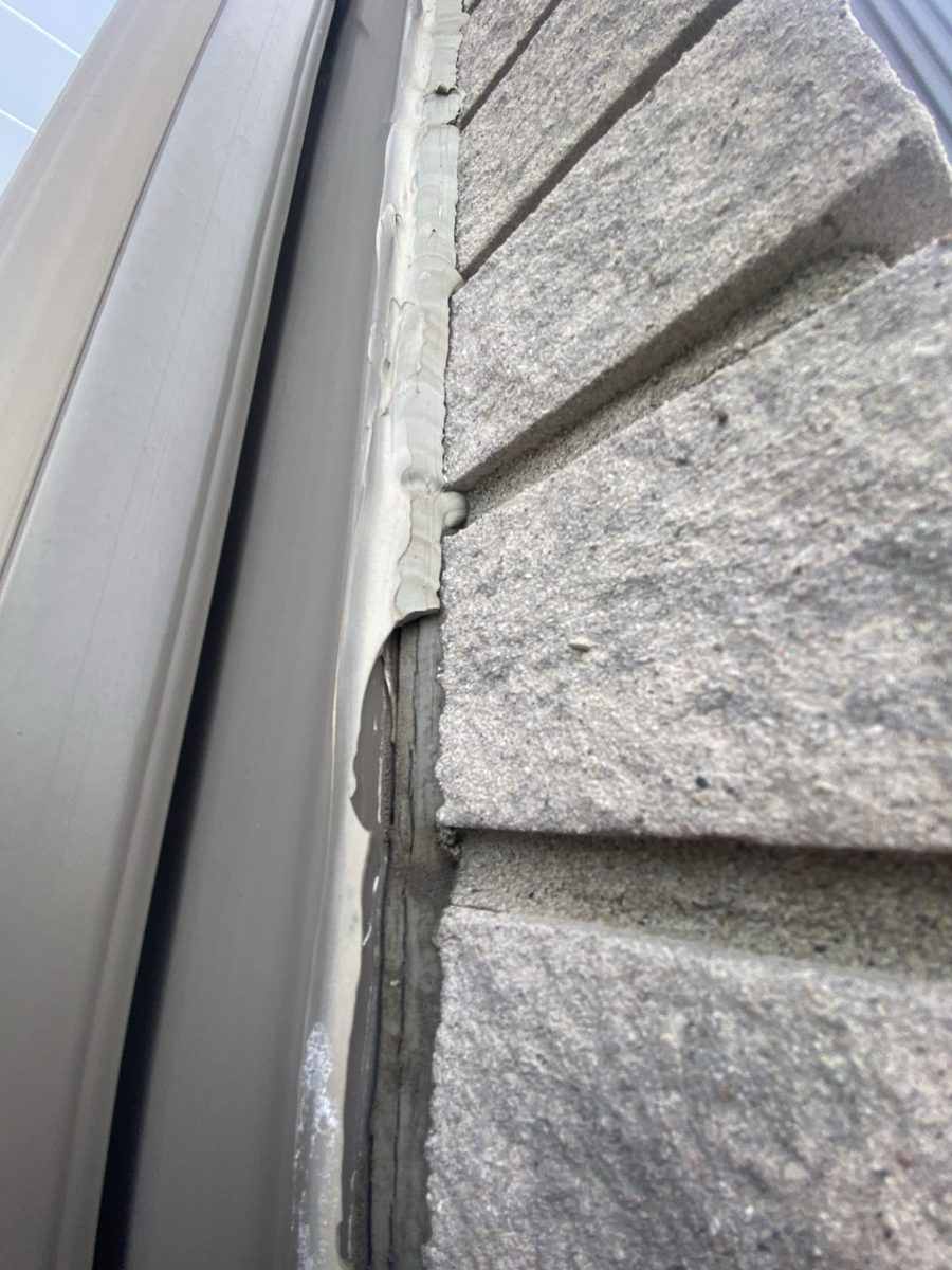 Before: Frame to stone — open joint cut clean and resealed in a matching tone